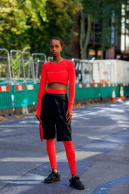 model, cropped top, red top, long sleeves top, asics top, lycra top, prada pants, black bermuda shorts, golden earrings, red legging, asics legging, nike shoes, black sneackers, sportswear, fashion week, frenchystyle, FW, jonathan paciullo, street style, vertical, full length