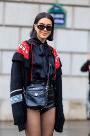 brittany xavier, versace sunglasses, black shirt, black pullover, black tights, black shorts, black leather bag, black sunglasses, vinyl shorts, mini shorts, miu miu bag, miu miu look, miu miu pullover, miu miu shirt, miu miu cardigan, miu miu shorts, lavalliere collar, embroidered pullover, floral embroidered pullover, floral embroidered cardigan, crossbody bag, red cardigan, strassed bag, satin shirt, PARIS, PFW, SPRING SUMMER 2020, SS 20, fashion week, frenchystyle, FW, jonathan paciullo, street style, vertical, atmosphere details, detail