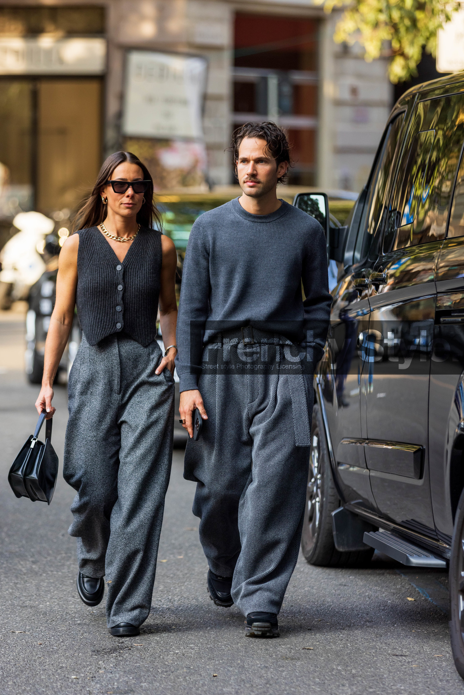 Alice Barbier, belted pants, black bag, black shoes, cardigan, couple, duo, gold chain, grey knit, grey monochrome, Jean-Sebastien Roques, knit, large pant, leather bag, leather shoes, menswear, monochrome, oversize pants, ribbed cardigan, sleveless cardigan, wool pants, sunglasses, black sunglasses, necklace, gold earrings, fashion week, frenchystyle, FW, jonathan paciullo, street style, MFW, MILAN, SPRING SUMMER 2022, SS 22, vertical, full length