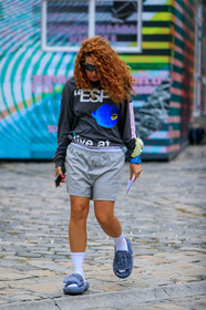 futurist shape sunglasses, black sunglasses, oakley sunglasses, dark grey t-shirt, letter printed t-shirt, long sleeves t-shirt, light grey shorts, calvin klein shorts, blue watch, blue slippers, flat slippers, white socks, sportswear, sportswear socks, sportswear shorts, fashion week, frenchystyle, FW, jonathan paciullo, street style, PFW, PARIS, SPRING SUMMER 2020, SS 20, horizontal, full length