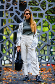 kaki top, knit top, knitwear, sleeveless top, white trench coat, white jacket, white jeans, long jacket, bandana printed jacket, bandana printed trenchcoat, cropped jeans, flare jeans, black sneackers, black leather bag, bucket bag, silvered necklace, printed trench coat, jacqueline zelwis, street style, jonathan paciullo, FW, frenchystyle, fashion week, MFW, MILAN, SPRING SUMMER 2021, SS 21, vertical, full length