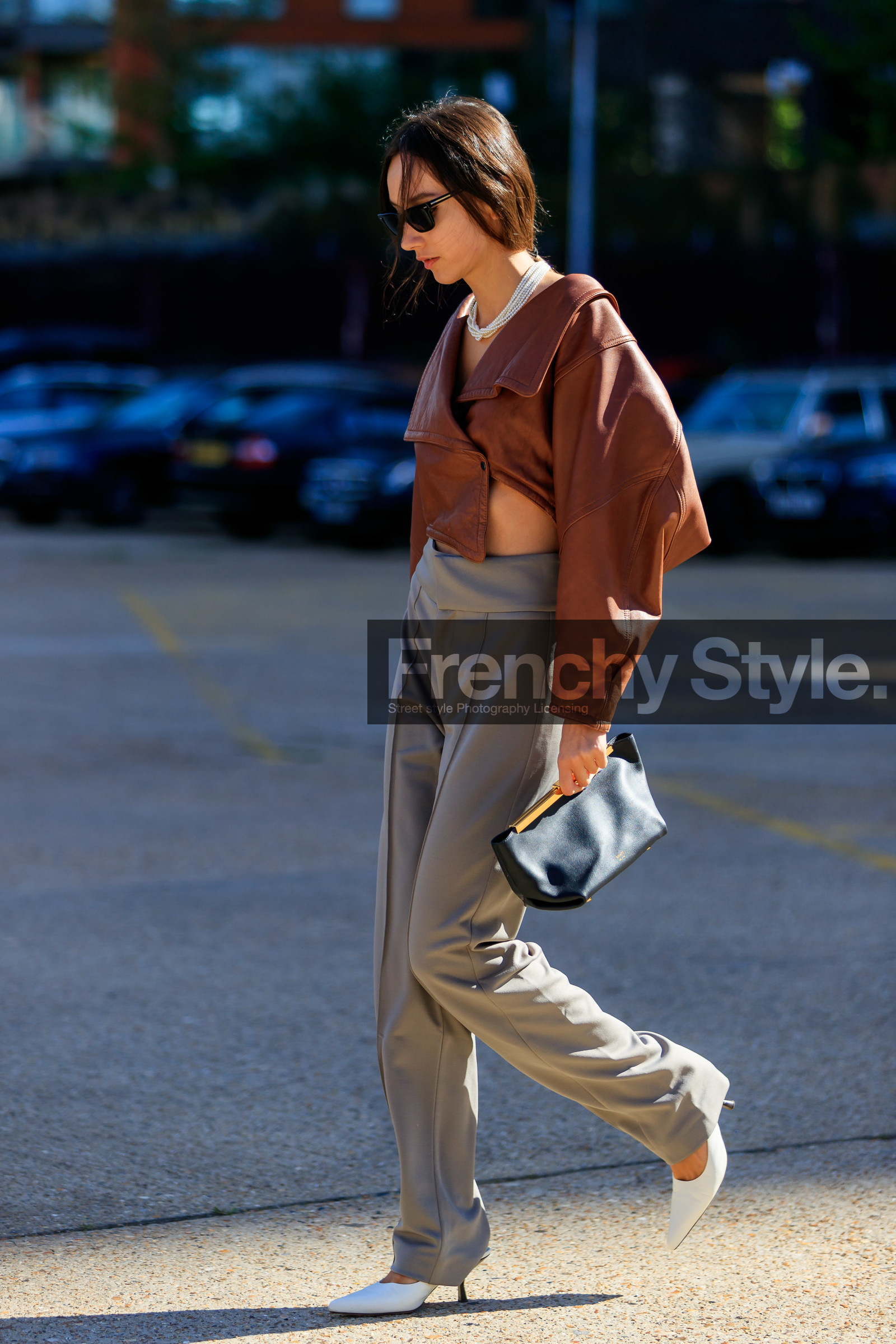 beatrice gutu, brown leather top, cropped top, asymmetrical top, long sleeves top, grey pants, white leather shoes, sharp end shoes, khaite bag, black leather clutch, multi necklace, pearl necklace, black sunglasses, fashion week, frenchystyle, FW, jonathan paciullo, street style, vertical, full length