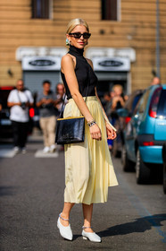 black bag, black top, caro daur, earrings, leather bag, leather shoes, pleated skirt, sunglasses, white shoes, yellow skirt, fashion week, frenchystyle, FW, jonathan paciullo, street style, MFW, MILAN, SPRING SUMMER 2019, SS 19, vertical, full length