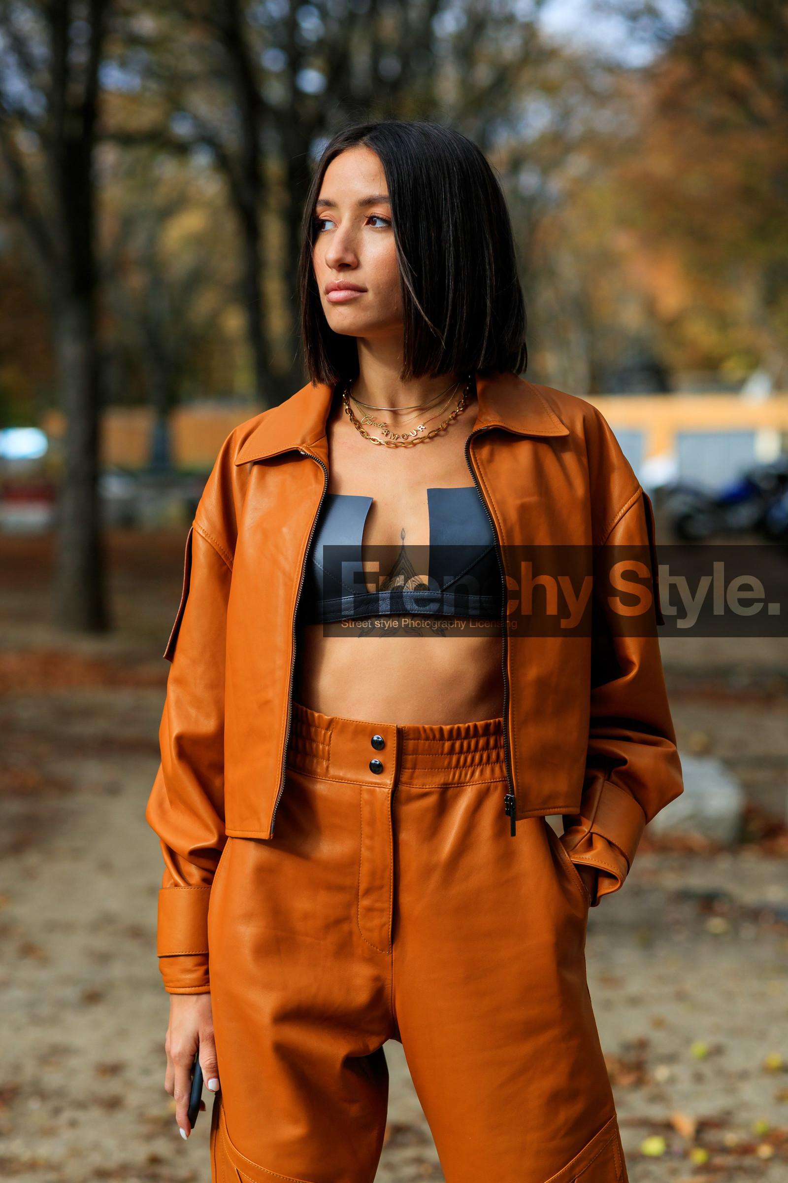 alexandra guerain, orange leather jacket, orange leather pants, orange total look, zipped jacket, black bra, cropped top, low necked top, black leather top, multi necklace, chain necklace, letters necklace, golden necklace, PARIS, PFW, SPRING SUMMER 2020, SS 20, fashion week, frenchystyle, FW, jonathan paciullo, street style, vertical, atmosphere details, detail