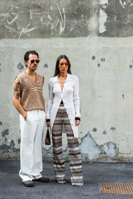 Alice Barbier, beige knit, beige pants, brown bag, brown clog, couple, duo, fluid pants, Jean-Sebastien Roques, knitted pants, leather bag, missoni look, orange sunglasses, printed pants, ribbed cardigan, sleveless knit, striped knit, sunglasses, white cardigan, white pants, v-neck knit, fashion week, frenchystyle, FW, jonathan paciullo, street style, MFW, MILAN, SPRING SUMMER 2022, SS 22, vertical, full length, menswear
