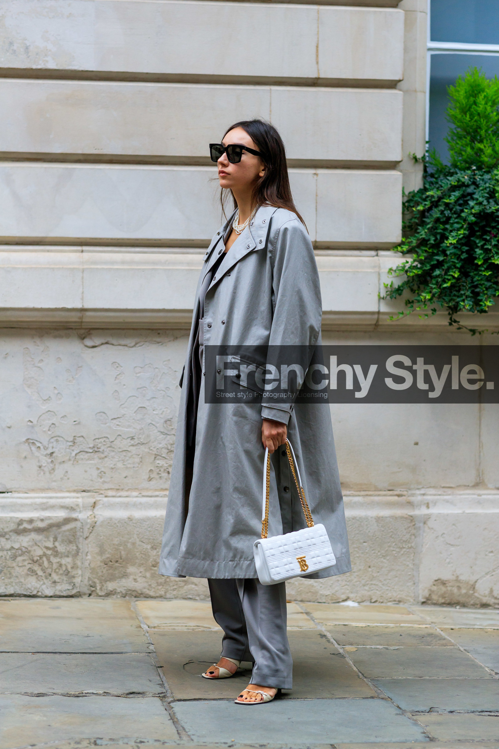 beatrice gutu, celine sunglasses, black sunglasses, square shape glasses, light grey trench coat, oversize trench coat, white leather bag, burberry bag, golden chain strap bag, quilted bag, grey pants, white leather sandals, pearl necklace, multi necklace, fashion week, frenchystyle, FW, jonathan paciullo, street style, vertical, full length
