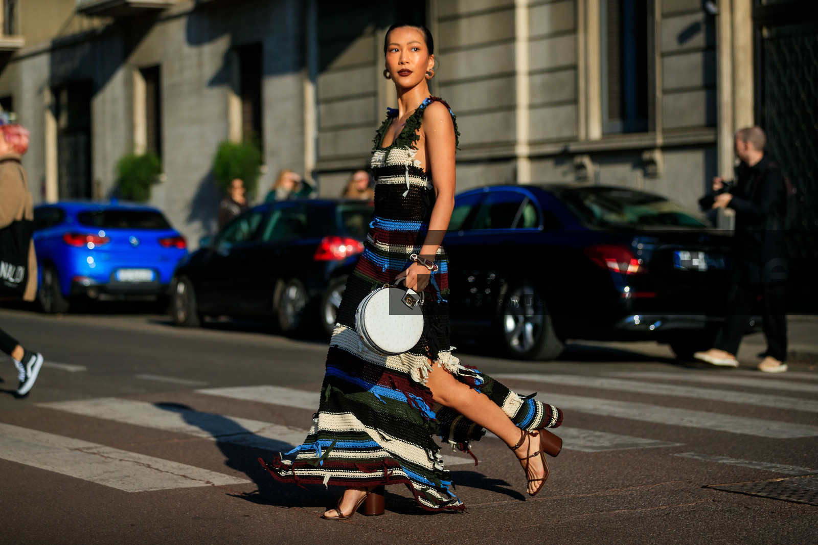 knit dress, knitwear, striped dress, sleeveless dress, long dress, animal shape bag, white leather bag, round shape bag, hand bag, kaki dress, blue dress, burgundy dress, multicolor dress, multicolor earrings, hoop earrings, split dress, brown leather sandals, multi straps sandals, high heels sandals, round shape heels, fringe dress, ferragamo bag, fashion week, frenchystyle, FW, jonathan paciullo, street style, MFW, MILAN, AUTUMN WINTER 2020-2021, FALL WINTER 2020-2021, FW 20-21, horizontal, atmosphere details, full length