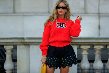 emili sindlev, red pullover, chanel pullover, knitwear, black sunglasses, square shape glasses, hoop earrings, golden earrings, black shorts, quilted shorts, embroidered shorts, floral embroidered shorts, ruffle shorts, golden sandals, multi straps sandals, knot details shoes, yellow clutch, plaited leather bag, fashion week, frenchystyle, FW, jonathan paciullo, street style, atmosphere details, horizontal, detail