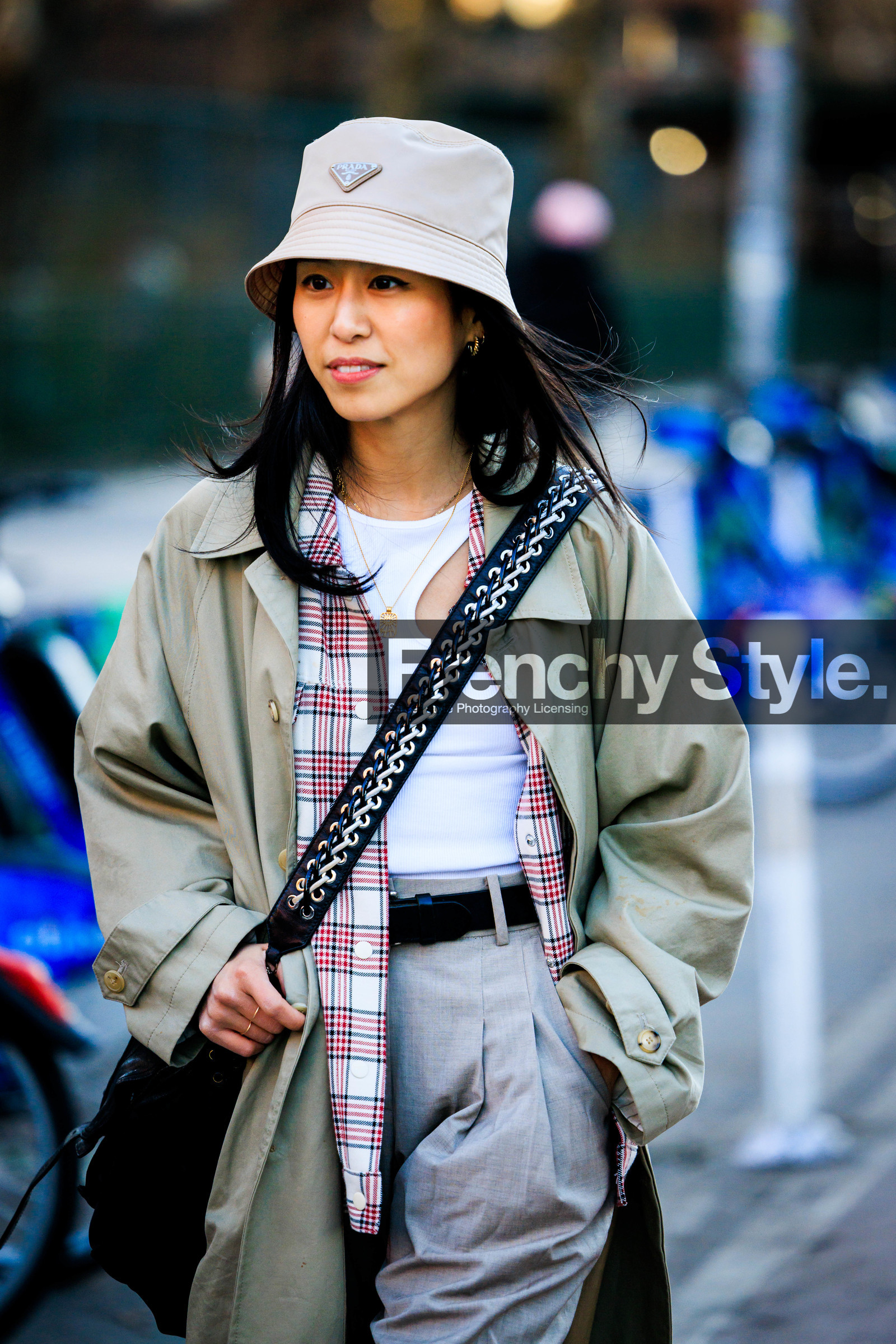 beige prada bucket hat, cut out white top, kaki trench coat, black belt, crossbody studs bag, red and white plaid shirt, close up, fashion week, frenchystyle, FW, jonathan paciullo, street style, NYFW, NEW YORK, AUTUMN WINTER 2022-2023, FALL WINTER 2022_2023, FW 22-23, vertical, atmosphere details