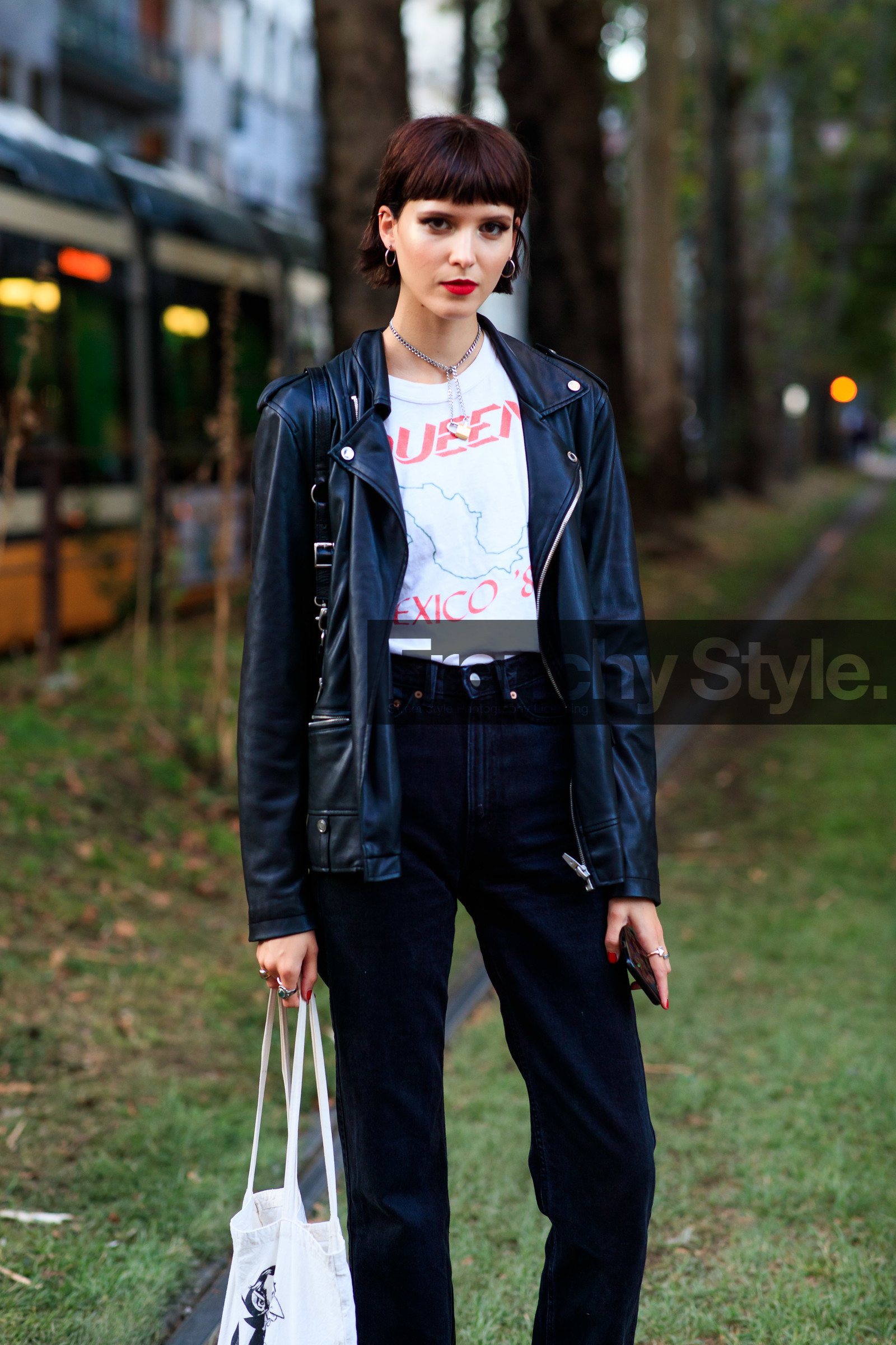 black jeans, black leather perfecto, white t-shirt, letter printed t-shirt, cropped jeans, flare jeans, silvered earrings, silvered necklace, chain necklace, padlock necklace, hoop earrings, red lipstick, street style, jonathan paciullo, FW, frenchystyle, fashion week, MFW, MILAN, SPRING SUMMER 2021, SS 21, vertical, detail, model