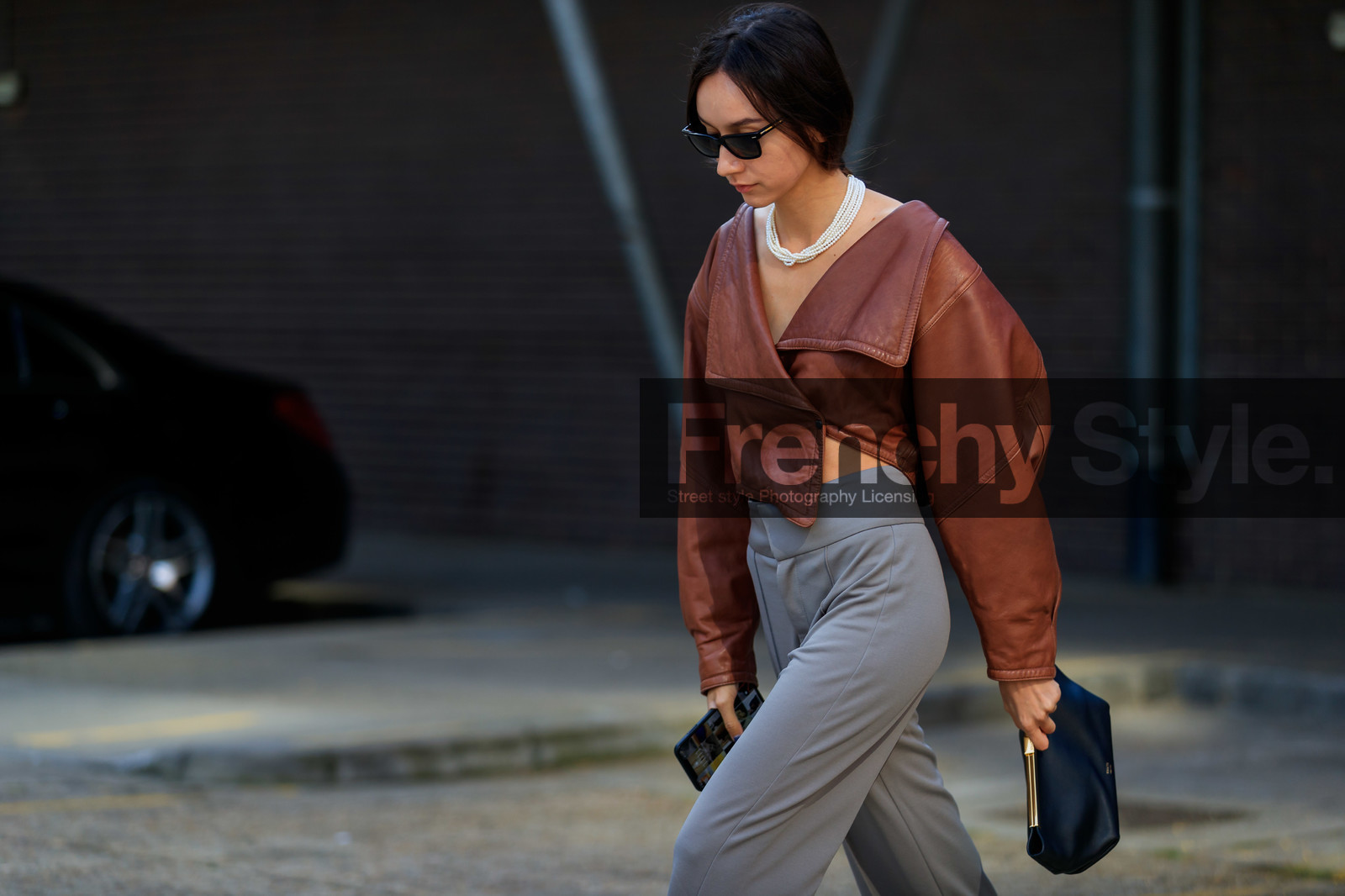 beatrice gutu, brown leather top, cropped top, asymmetrical top, long sleeves top, grey pants, white leather shoes, sharp end shoes, khaite bag, black leather clutch, multi necklace, pearl necklace, black sunglasses, fashion week, frenchystyle, FW, jonathan paciullo, street style, atmosphere details, horizontal, detail
