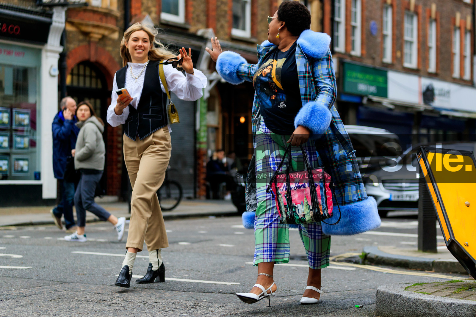 aemilia madden, gabriella karefa johnson, light blue coat, light green pants, checked coat, checked pants, satin pants, silk pants, fur coat, plaid coat, plaid pants, cropped pants, white leather shoes, prada shoes, high heels shoes, sharp end shoes, ankle bracelet, balenciaga bag, pink bag, hand bag, printed bag, printed t-shirt, face printed t-shirt, black t-shirt, the north face t-shirt, fashion week, frenchystyle, FW, jonathan paciullo, street style, LFW, LONDON, AUTUMN WINTER 2020-2021, FALL WINTER 2020-2021, FW 20-21, horizontal, atmosphere details, full length