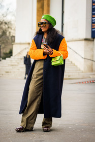 ganni beanie, green beanie, orange sleeves, black winter coat, kaki pants, baggy trousers, studded clogs, green handbag, black sunglasses, ganni cardigan, fashion week, frenchystyle, FW, jonathan paciullo, street style, AUTUMN WINTER 2022-2023, FALL WINTER 2022_2023, FW 22-23, PFW, PARIS, vertical, full length, dual toned jakcet