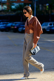 beatrice gutu, brown leather top, cropped top, asymmetrical top, long sleeves top, grey pants, white leather shoes, sharp end shoes, khaite bag, black leather clutch, multi necklace, pearl necklace, black sunglasses, fashion week, frenchystyle, FW, jonathan paciullo, street style, vertical, full length