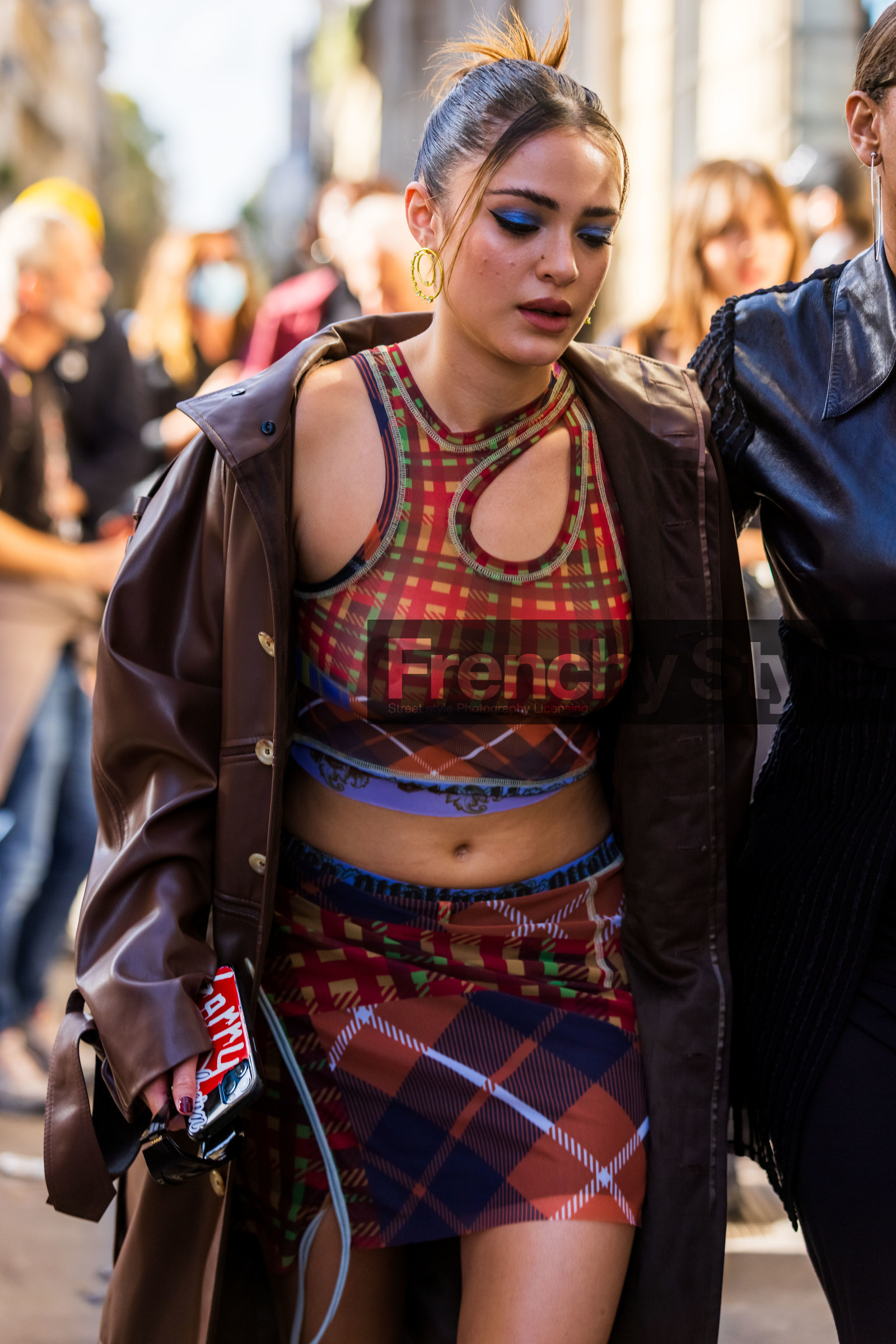 blue eyeshadow, brown coat, checked print, checked top, coat, crop top, cut out top, earrings, gold earrings, leather coat, Luna Blaise, makeup, mini skirt, printed skirt, printed top, red skirt, red top, skirt, top, street style, jonathan paciullo, FW, frenchystyle, fashion week, PFW, PARIS, SPRING SUMMER 2022, SS 22, vertical, atmosphere details