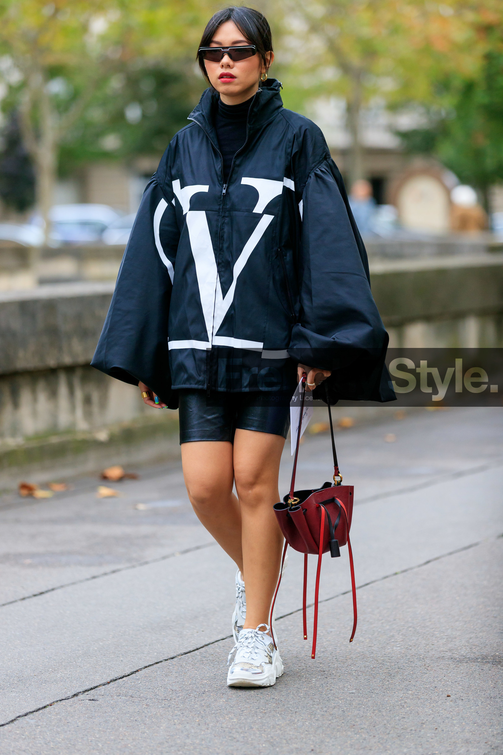 valentino coat, black coat, black parka, black top, black total look, black leather shorts, tight shorts, black sunglasses, futurist shape sunglasses, balenciaga sunglasses, turtleneck top, burgundy leather bag, white sneakers, PARIS, PFW, SPRING SUMMER 2020, SS 20, fashion week, frenchystyle, FW, jonathan paciullo, street style, vertical, full length
