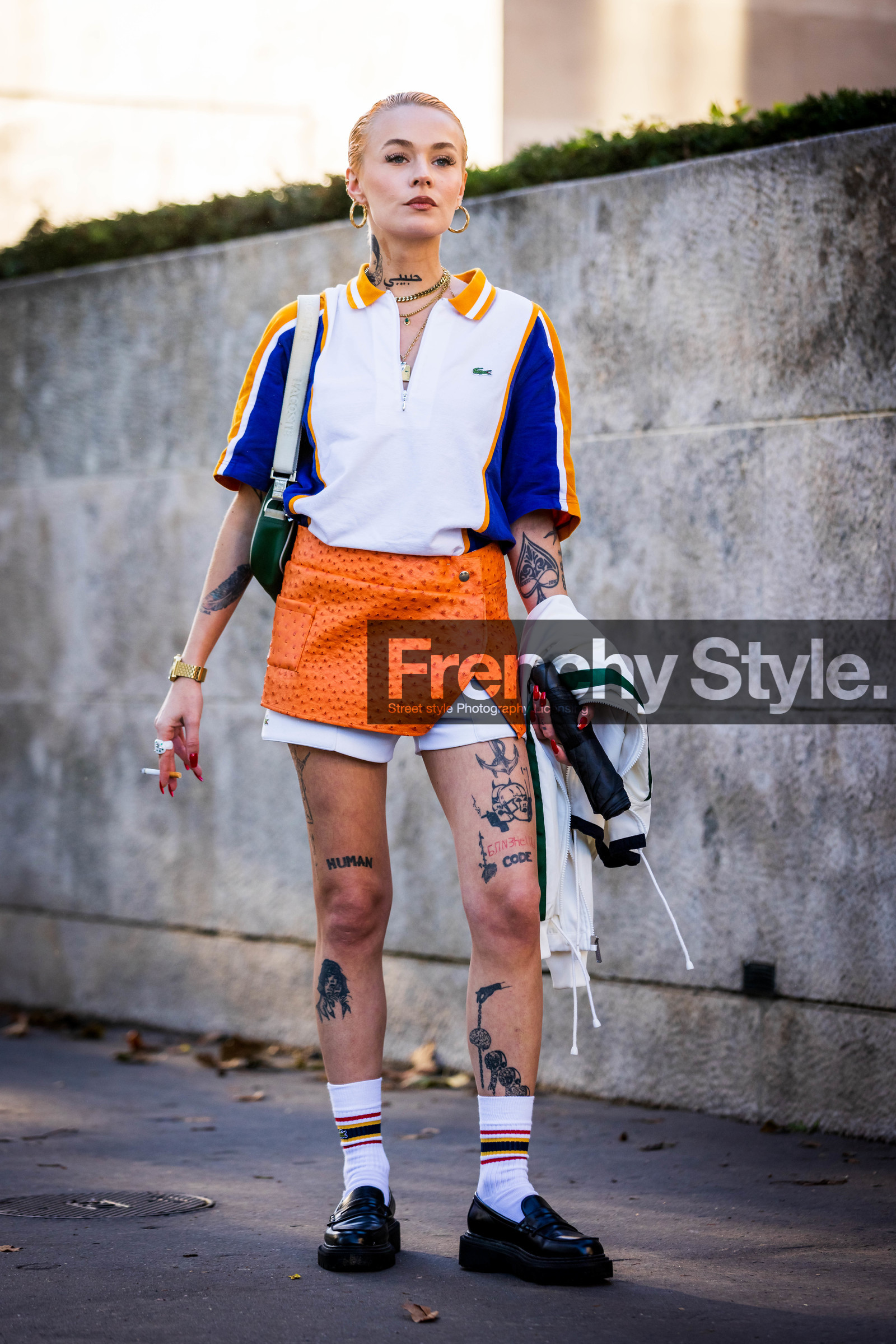 black loafers, black mocassins, blue polo, lacoste look, loafers, mini skirt, mocassins, Moesta Errabunda, orange skirt, polo, skirt, socks, tattoo, white polo, white shorts, white socks, zipped polo, lacoste, fashion week, frenchystyle, FW, jonathan paciullo, street style, PFW, PARIS, SPRING SUMMER 2022, SS 22, vertical, full length