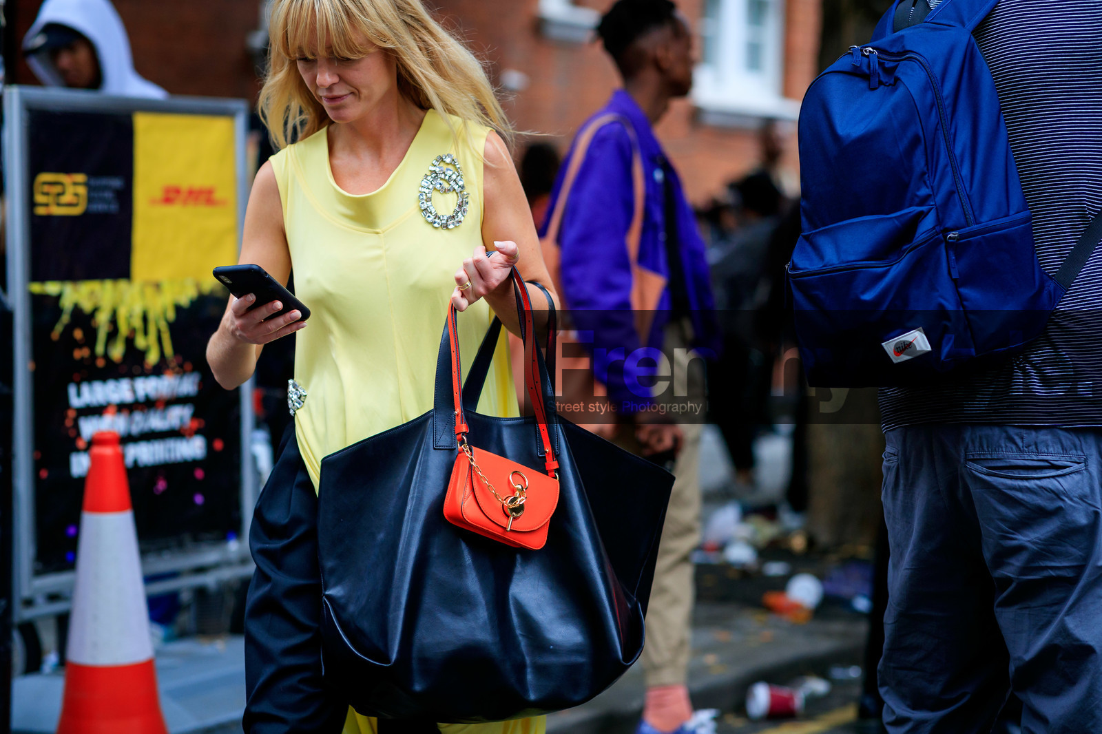 jeanette madsen, yellow dress, sleeveless dress, strassed pin, bag detail, shopping bag, black leather bag, orange leather bag, mini bag, close up detail, j w anderson bag, fashion week, frenchystyle, FW, jonathan paciullo, street style, atmosphere details, horizontal, detail