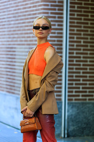 nose piercing, black sunglasses, small sunglasses, futurist shape sunglasses, orange pants, orange top, cropped top, sleeveless top, beige jacket, red leather pants, red pants, tie and dye pants, mini bag, hand bag, animal skin bag, camel leather bag, hoop earrings, knit top, knitwear, fashion week, frenchystyle, FW, jonathan paciullo, street style, MFW, MILAN, SPRING SUMMER 2021, SS 21, vertical, detail