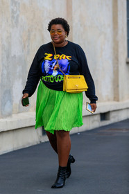 gabriella karefa johnson, neon green skirt, pleated skirt, mini skirt, long sleeves t-shirt, black sweatshirt, printed sweatshirt, prada bag, crossbody bag, yellow bag, chain strap bag, animal shape earrings, golden earrings, aviator sunglasses, yellow sunglasses, margiela boots, black leather boots, camel toe margiela boots, low boots, fashion week, frenchystyle, FW, jonathan paciullo, street style, MFW, MILAN, SPRING SUMMER 2020, SS 20