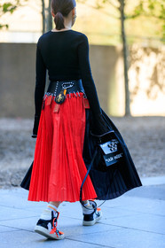 charlotte chesnais earrings, chopova lowena skirt, pleated skirt, black top, long sleeves top, sportswear socks, off white sneakers, off white bag, red and black skirt, black leather bag, letter printed bag, black and white sneakers, fashion week, frenchystyle, FW, jonathan paciullo, street style, vertical, detail, atmosphere details