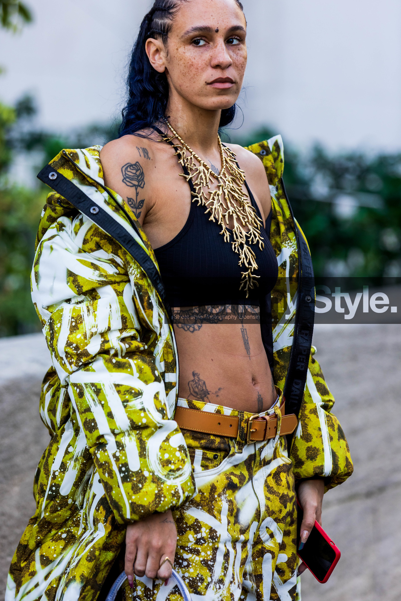 bag, belt, black bra, bra, camel belt, coat, freckles, gold necklace, Hera Pradel, leather belt, long coat, long puffer, necklace, nike sneakers, print, printed coat, printed pants, printed puffer, puffer, sneakers, statement necklace, tattoo, transparent bag, white sneakers, yellow coat, yellow pants, fashion week, frenchystyle, FW, jonathan paciullo, street style, PFW, PARIS, SPRING SUMMER 2022, SS 22, vertical, atmosphere details