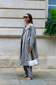 beatrice gutu, celine sunglasses, black sunglasses, square shape glasses, light grey trench coat, oversize trench coat, white leather bag, burberry bag, golden chain strap bag, quilted bag, grey pants, white leather sandals, pearl necklace, multi necklace, fashion week, frenchystyle, FW, jonathan paciullo, street style, vertical, full length