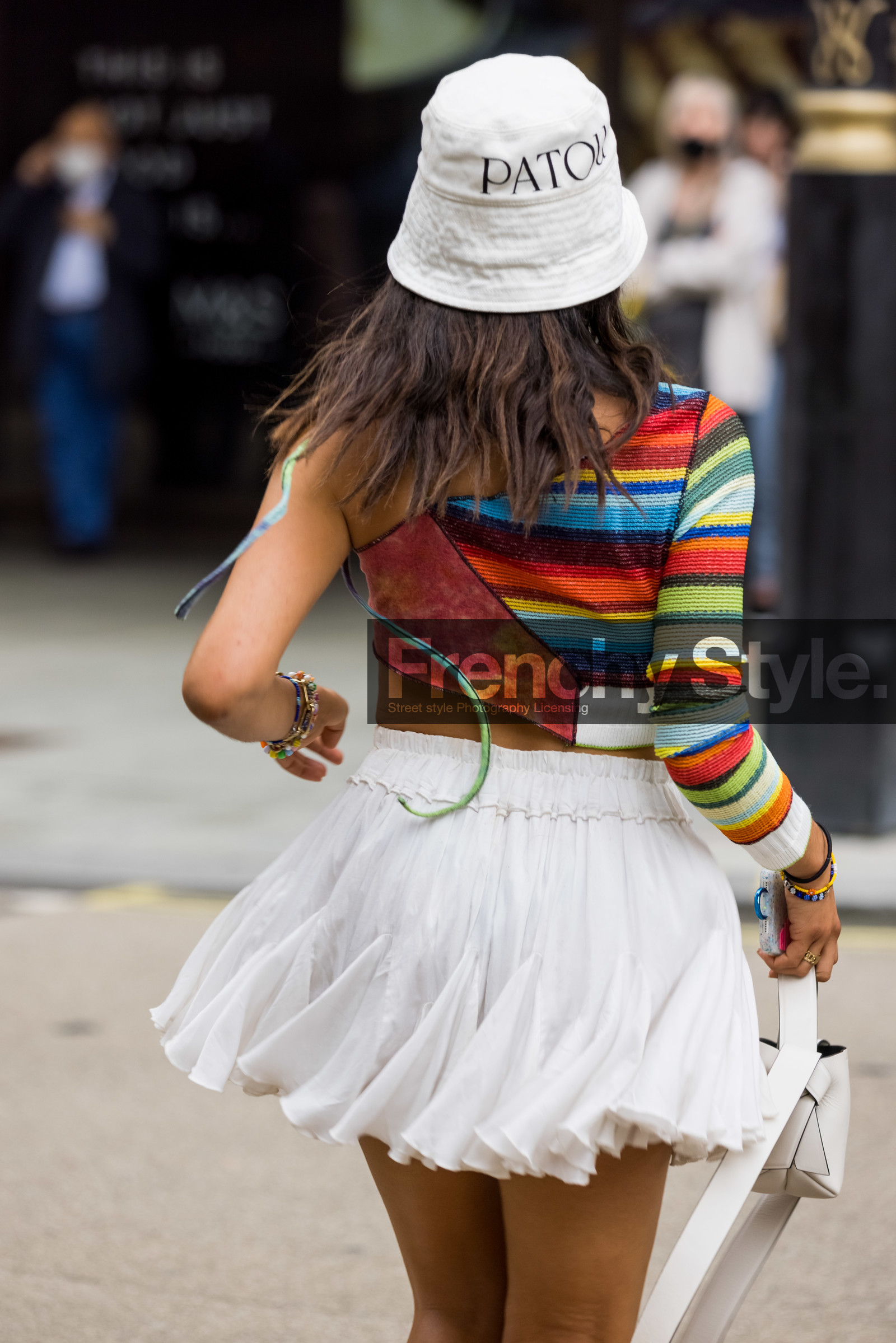 Selma Kaci, patou, knitted top, bucket hat, mini dress, ruffles, white, one sleeve, top, stripes, knits, acne studios, handbag, bracelet, fashion week, frenchystyle, FW, jonathan paciullo, street style, SPRING SUMMER 2022, SS 22, LFW, LONDON, vertical, atmosphere details, detail