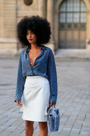 sharon alexie, blue shirt, blue bag, monogrammed shirt, low necked shirt, white skirt, ruffle skirt, mini skirt, hand bag, tweed bag, long necklace, golden necklace, animal shape necklace, charms necklace, louis vuitton bag, louis vuitton necklace, louis vuitton shirt, louis vuitton skirt, louis vuitton total look, white leather bag, PARIS, PFW, SPRING SUMMER 2020, SS 20, fashion week, frenchystyle, FW, jonathan paciullo, street style, vertical, atmosphere details, detail
