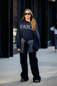 patou black sweatshirt, black cat eye sunglasses, silver pleated skirt, school girl skirt, oversiwed black pants, black and white sneakers, Allegra shaw, fashion week, frenchystyle, FW, jonathan paciullo, street style, NYFW, NEW YORK, AUTUMN WINTER 2022-2023, FALL WINTER 2022_2023, FW 22-23, vertical, full length