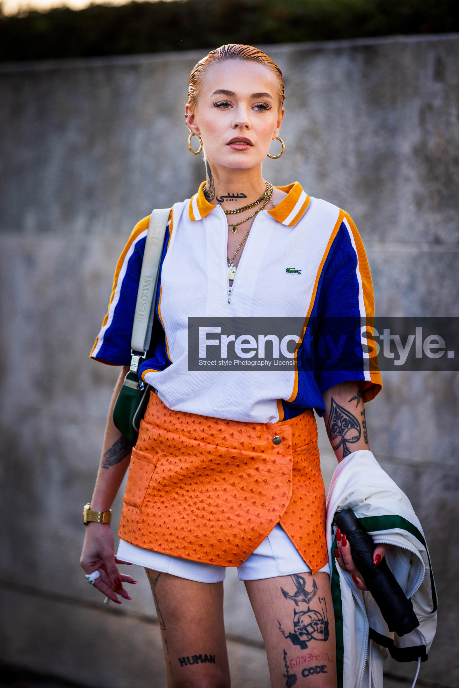 blue polo, gold watch, green bag, lacoste look, mini skirt, mocassins, Moesta Errabunda, orange skirt, polo, tattoo, watch, white polo, white shorts, zipped polo, lacoste, fashion week, frenchystyle, FW, jonathan paciullo, street style, PFW, PARIS, SPRING SUMMER 2022, SS 22, vertical, atmosphere details