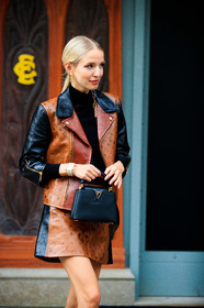 leonie hanne, camel leather perfecto, brown leather perfecto, black leather perfecto, brown leather skirt, camel leather skirt, black leather bag, black pullover, turtleneck pullover, golden earrings, dangling earrings, monogrammed jacket, monogrammed skirt, louis vuitton bag, louis vuitton jacket, louis vuitton skirt, louis vuitton earrings, golden watch, silvered watch, fendi watch, hand bag, PARIS, PFW, fashion week, frenchystyle, FW, jonathan paciullo, street style, SPRING SUMMER 2021, SS 21, vertical, atmosphere details, detail