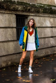 blue jacket, color, jacket, jumper, knitwear, lacoste look, mini skirt, Monica de la Villardière, pleated skirt, skirt, sneakers, socks, tennis look, v neck jumper, white jumper, white skirt, white sneakers, white socks, yellow jacket, lacoste, fashion week, frenchystyle, FW, jonathan paciullo, street style, PFW, PARIS, SPRING SUMMER 2022, SS 22, vertical, full length