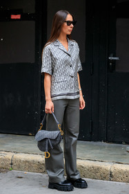 grey leather pants, loose pants, flare pants, black leather boots, big sole boots, laced boots, flat boots, dior bag, dior pants, dior saddle bag, dior total look, dior shirt, prada boots, prada shoes, grey bag, monogrammed bag, logo printed bag, grey shirt, grey total look, short sleeves shirt, monogrammed shirt, silk shirt, logo printed shirt, eyecat sunglasses, celine sunglasses, black sunglasses, pyjama shirt, fashion week, frenchystyle, FW, jonathan paciullo, street style, PFW, PARIS, SPRING SUMMER 2022, SS 22, vertical, full length